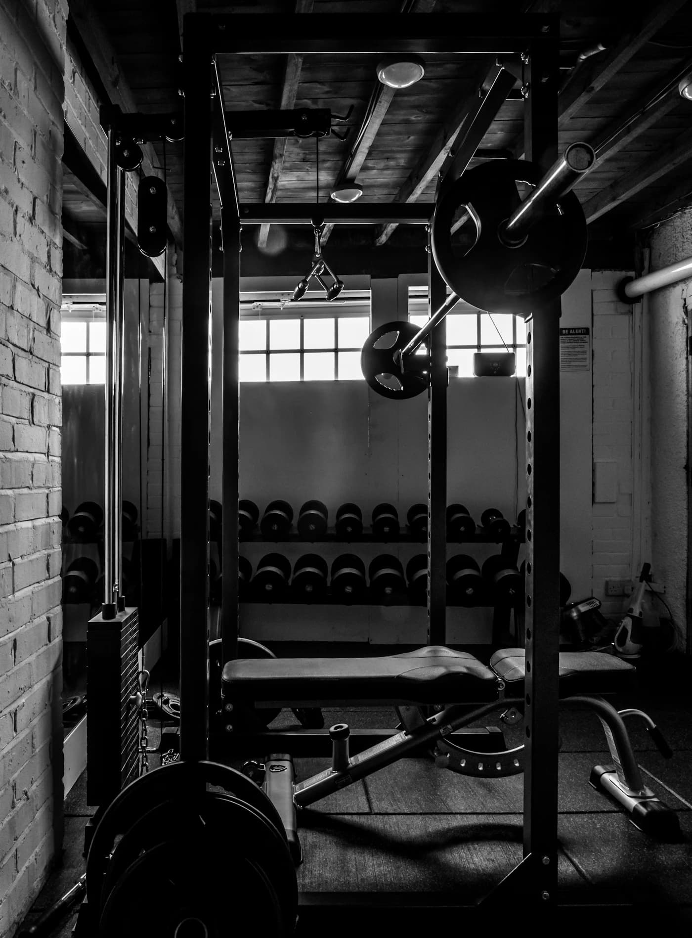 Dark gym floor with racks and weights at Feel Alive Fitness